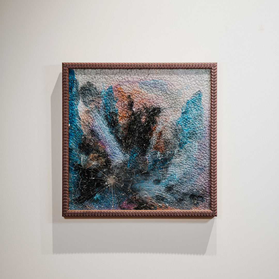 Framed abstract artwork on a white wall